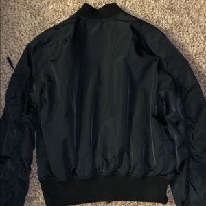 Men’s black bomber jacket with multi pockets.